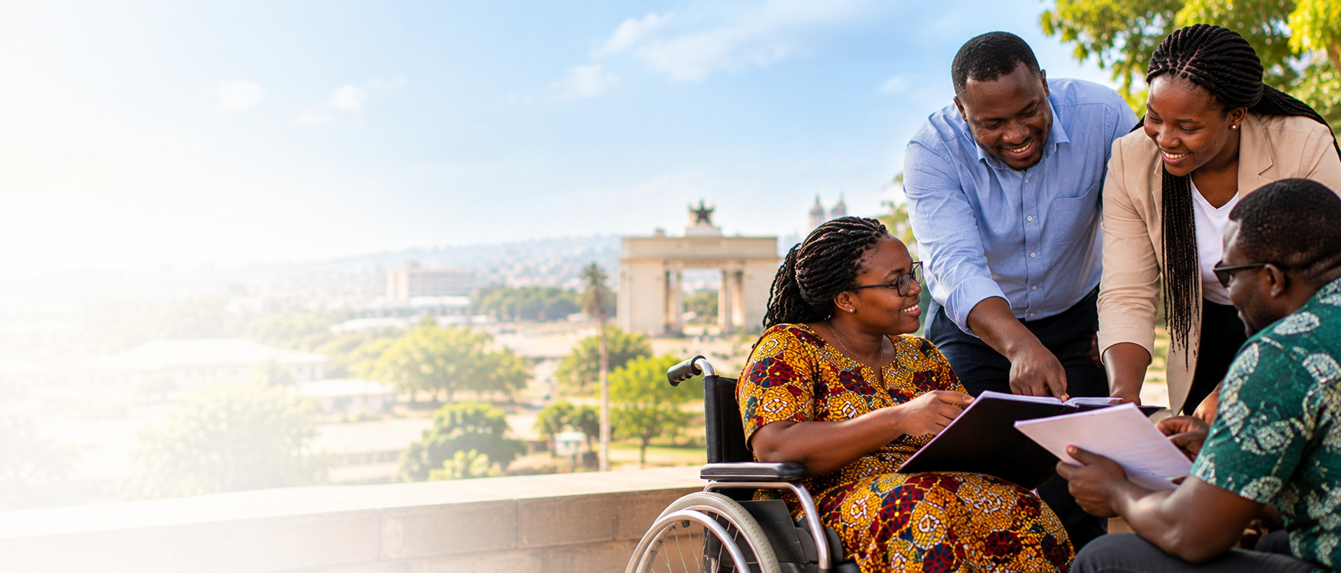 Workshop participants, including a wheelchair user, reviewing documents