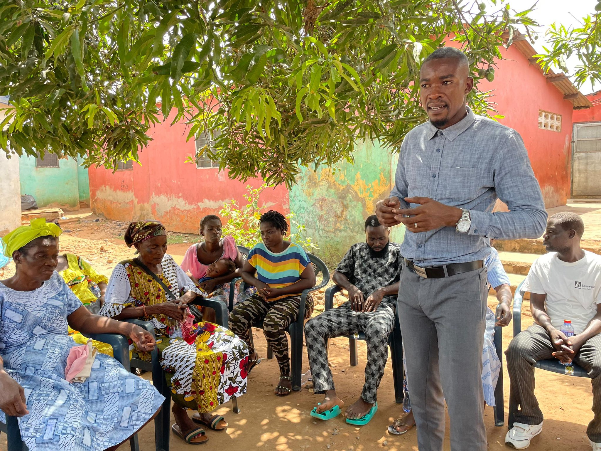 BasicNeeds-Ghana staff talking with community members